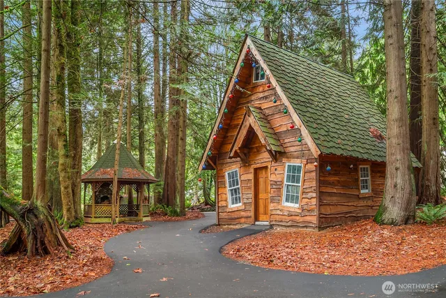 a view of a large trees in front of a house
