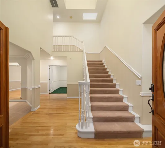 an empty room with windows and fireplace