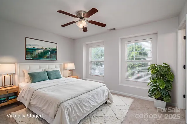 a bedroom with a large bed and a window