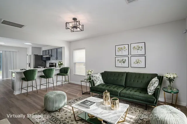 a living room with furniture a rug and a chandelier