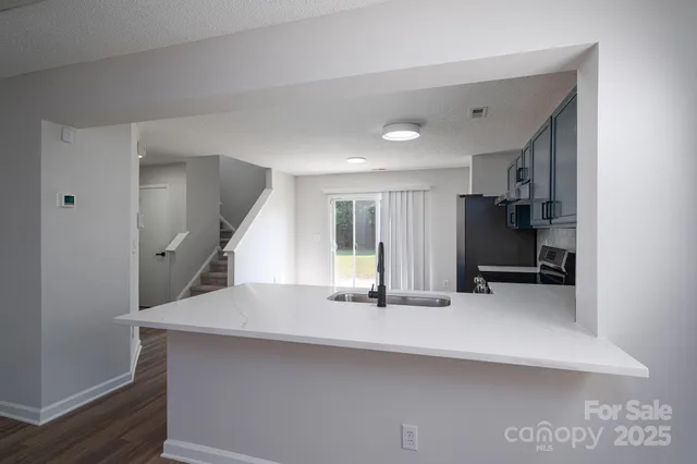 a view of an empty room with a fireplace and a window
