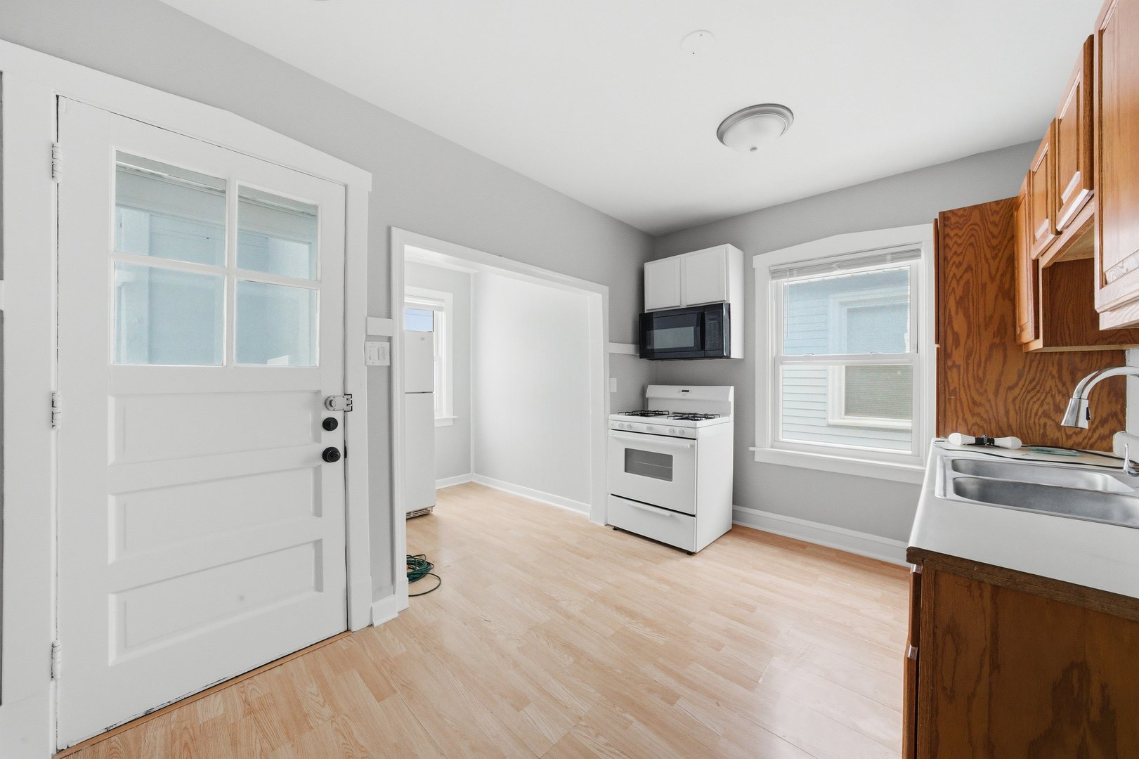 5301 West Winona Street, Unit 2 Chicago, IL 60630 - Photo 5 of 11 a kitchen with stainless steel appliances a refrigerator and a stove top oven