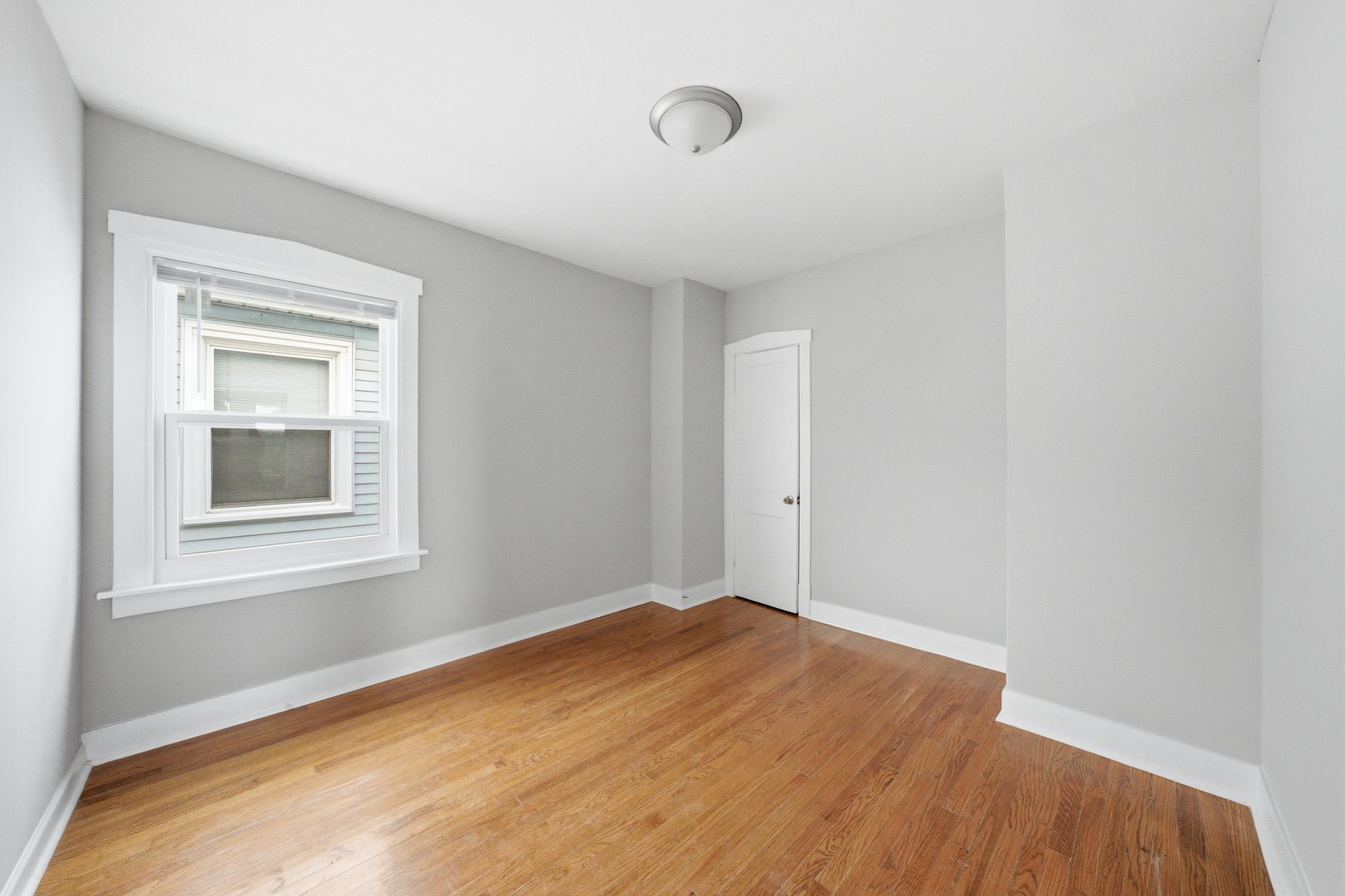 5301 West Winona Street, Unit 2 Chicago, IL 60630 - Photo 6 of 11 a view of empty room with wooden floor and fan
