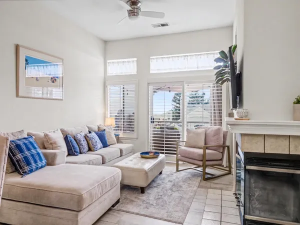 a living room with furniture and a fireplace