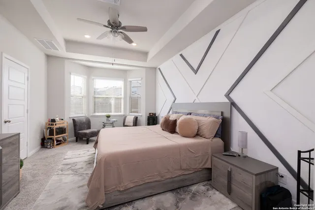 a bedroom with a bed couch and a window