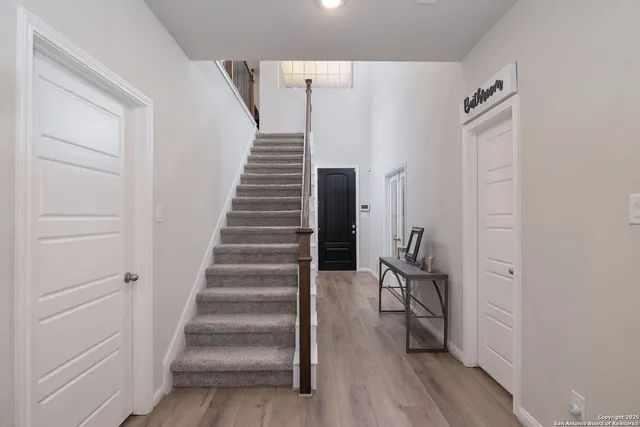 a view of entryway with wooden floor and stairs