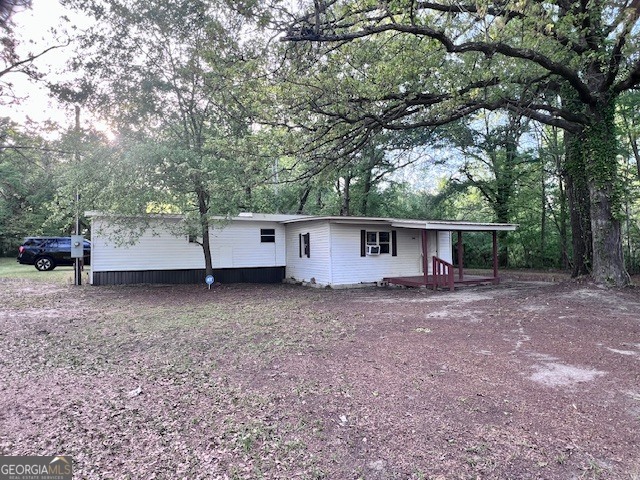 3195 Henderson Grove Road Sandersville, GA 31082 - Photo 20 of 50 a view of a house with a yard and tree s