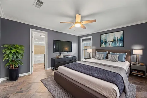 a bedroom with a large bed and a flat screen tv