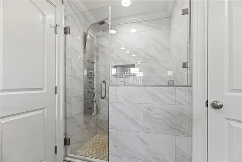 a bathroom with a glass shower door