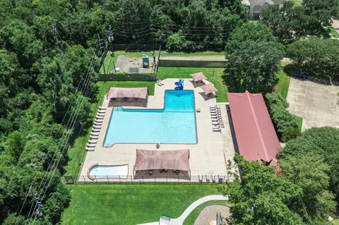 an aerial view of a house with outdoor space pool seating area and yard