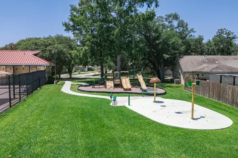 a view of a house with a backyard and patio