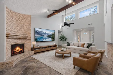 a living room with furniture and a fireplace