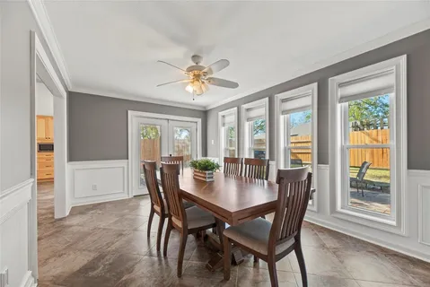 a view of a dining room with furniture a chandelier and wooden floor