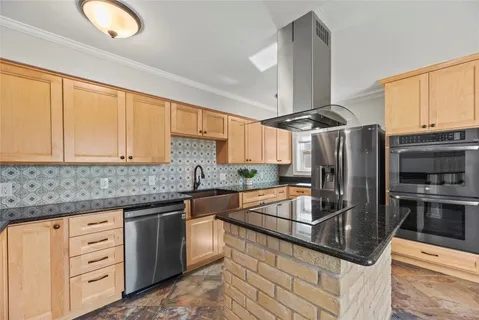 a kitchen with stainless steel appliances granite countertop a sink stove and refrigerator