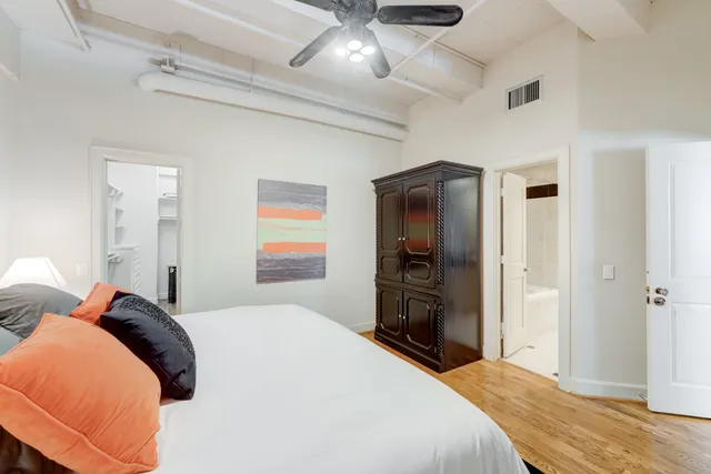 a bedroom with a bed and a chandelier