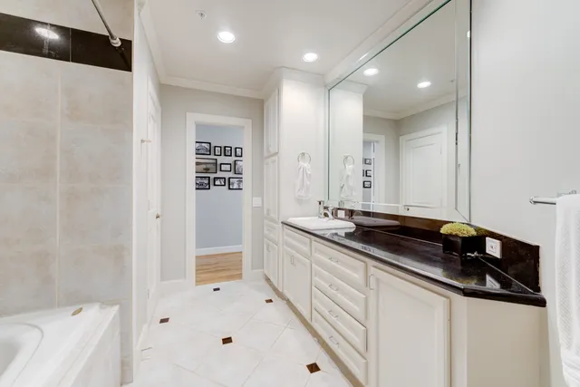 a large white kitchen with a large sink