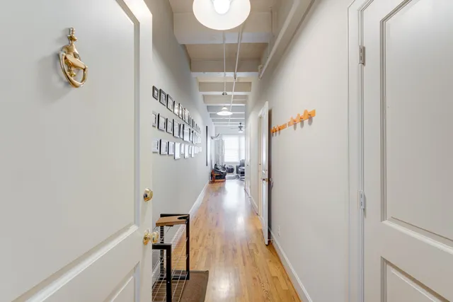 a view of a hallway view with wooden floor and staircase