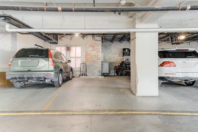 a view of parking garage with cars