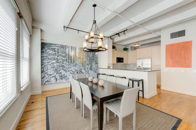 a view of a dining room with furniture window and wooden floor