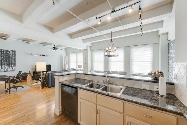 a kitchen with a sink appliances and a counter space