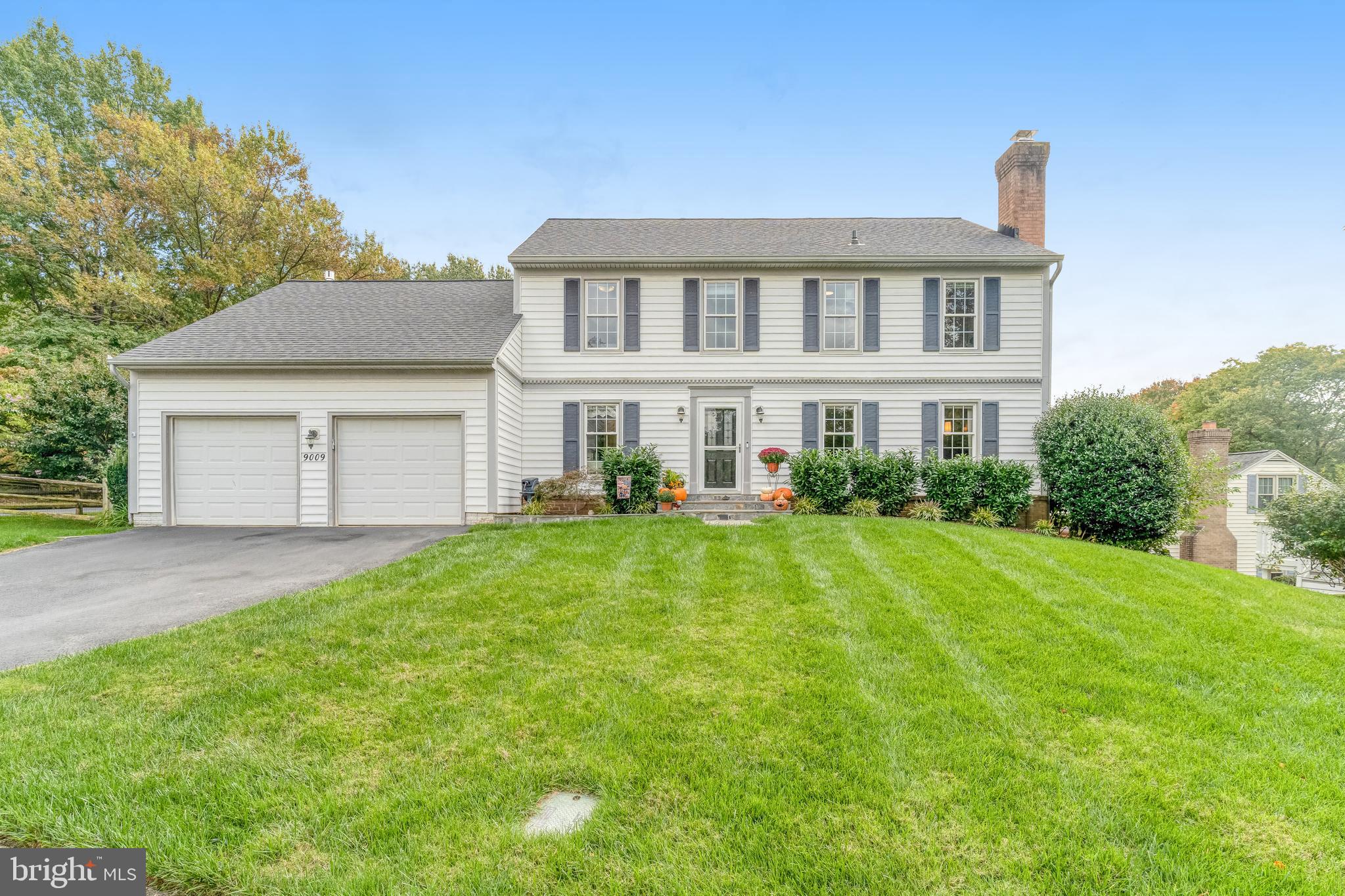 9009 Digory Court Burke, VA 22015 - Photo 1 of 51 a view of a house with a yard and sitting area