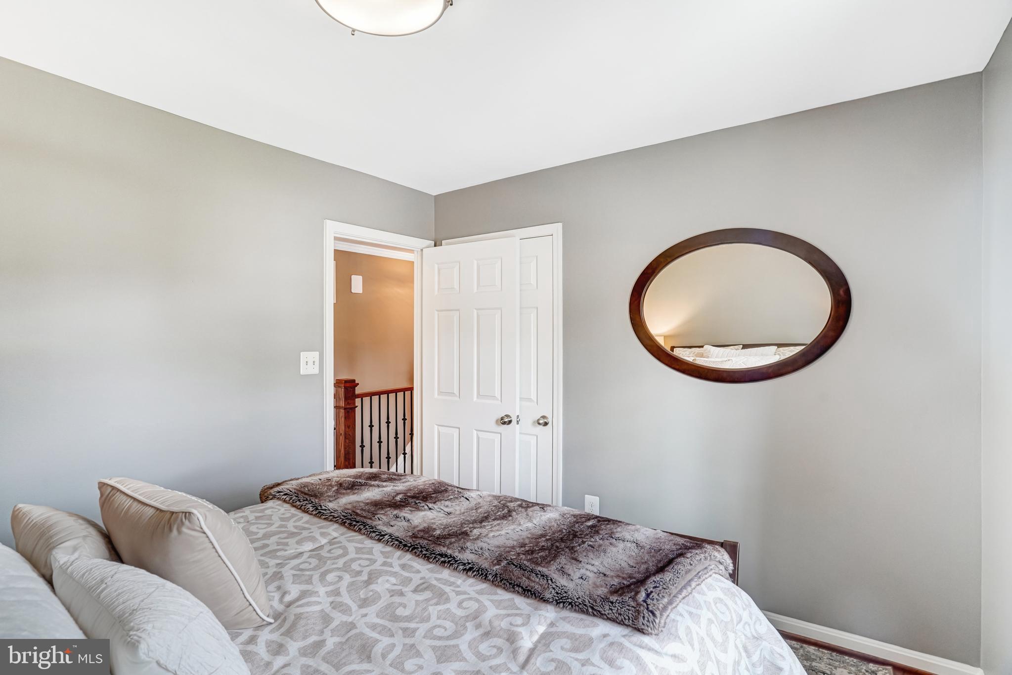 9009 Digory Court Burke, VA 22015 - Photo 11 of 51 a bedroom with a bed and a chandelier