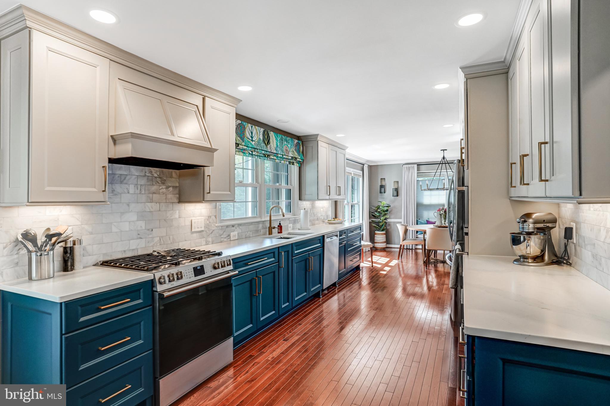 9009 Digory Court Burke, VA 22015 - Photo 26 of 51 a kitchen with stainless steel appliances a stove a sink dishwasher and cabinets with wooden floor