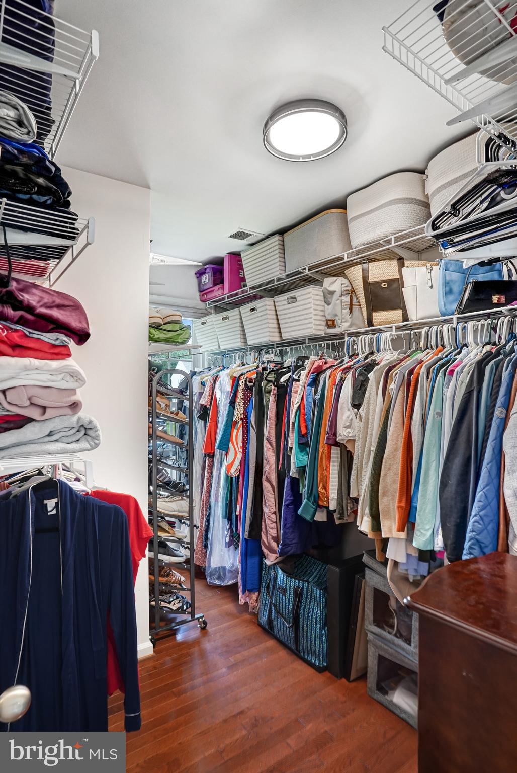 9009 Digory Court Burke, VA 22015 - Photo 4 of 51 a view of walk in closet with clothes and shoes