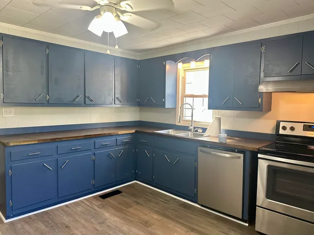 a kitchen with a sink cabinets and window