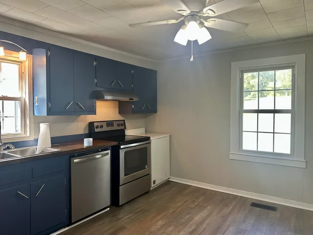 a kitchen with stainless steel appliances granite countertop a stove and a sink