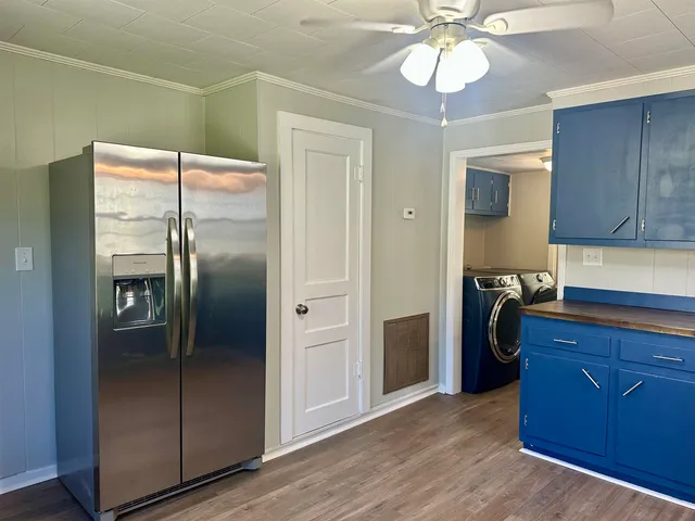 a kitchen with a refrigerator and a sink