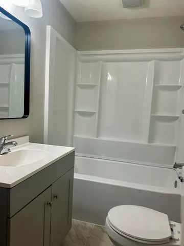 a bathroom with a sink a toilet and a bathtub