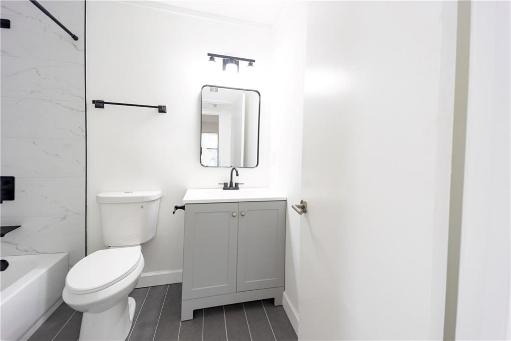 2712 Huntingdon Chase Atlanta, GA 30350 - Photo 11 of 27 a bathroom with a toilet sink and mirror