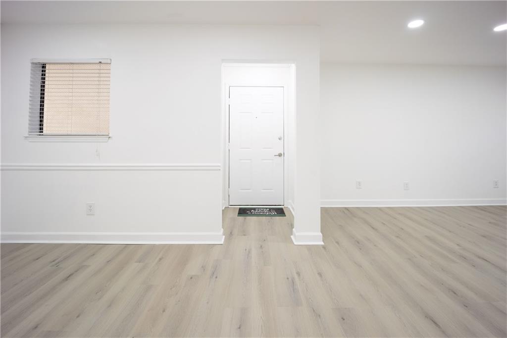 2712 Huntingdon Chase Atlanta, GA 30350 - Photo 13 of 27 an empty room with wooden floor and windows