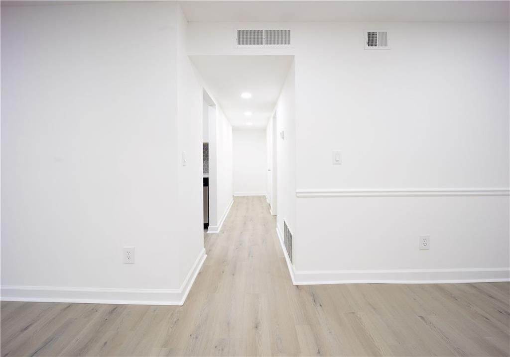 2712 Huntingdon Chase Atlanta, GA 30350 - Photo 16 of 27 a view of a hallway with wooden floor