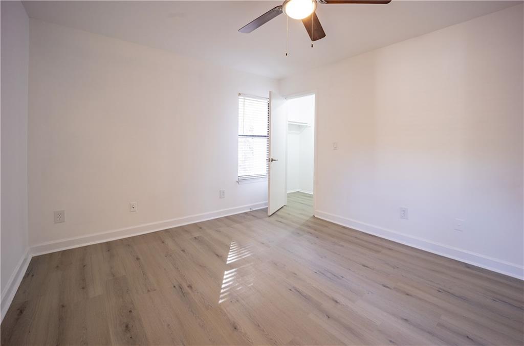2712 Huntingdon Chase Atlanta, GA 30350 - Photo 17 of 27 an empty room with wooden floor ceiling fan and window