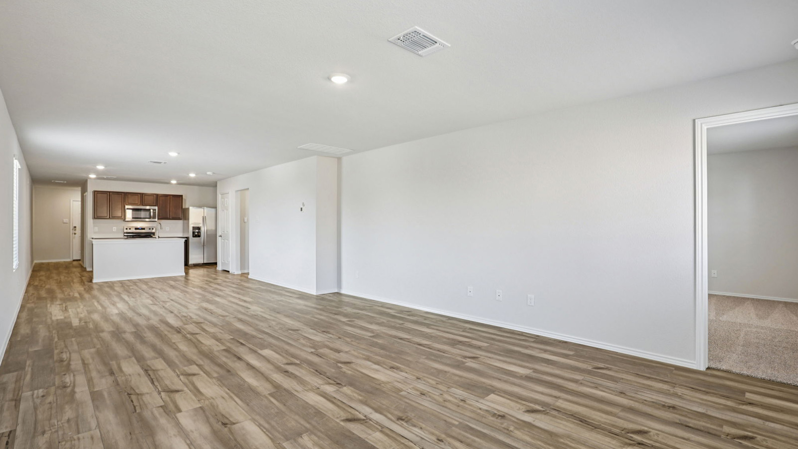 156 Wyatt Way Jarrell, TX 76537 - Photo 14 of 30 Open-concept room featuring wood-finish flooring, recessed lighting, and a neutral color palette