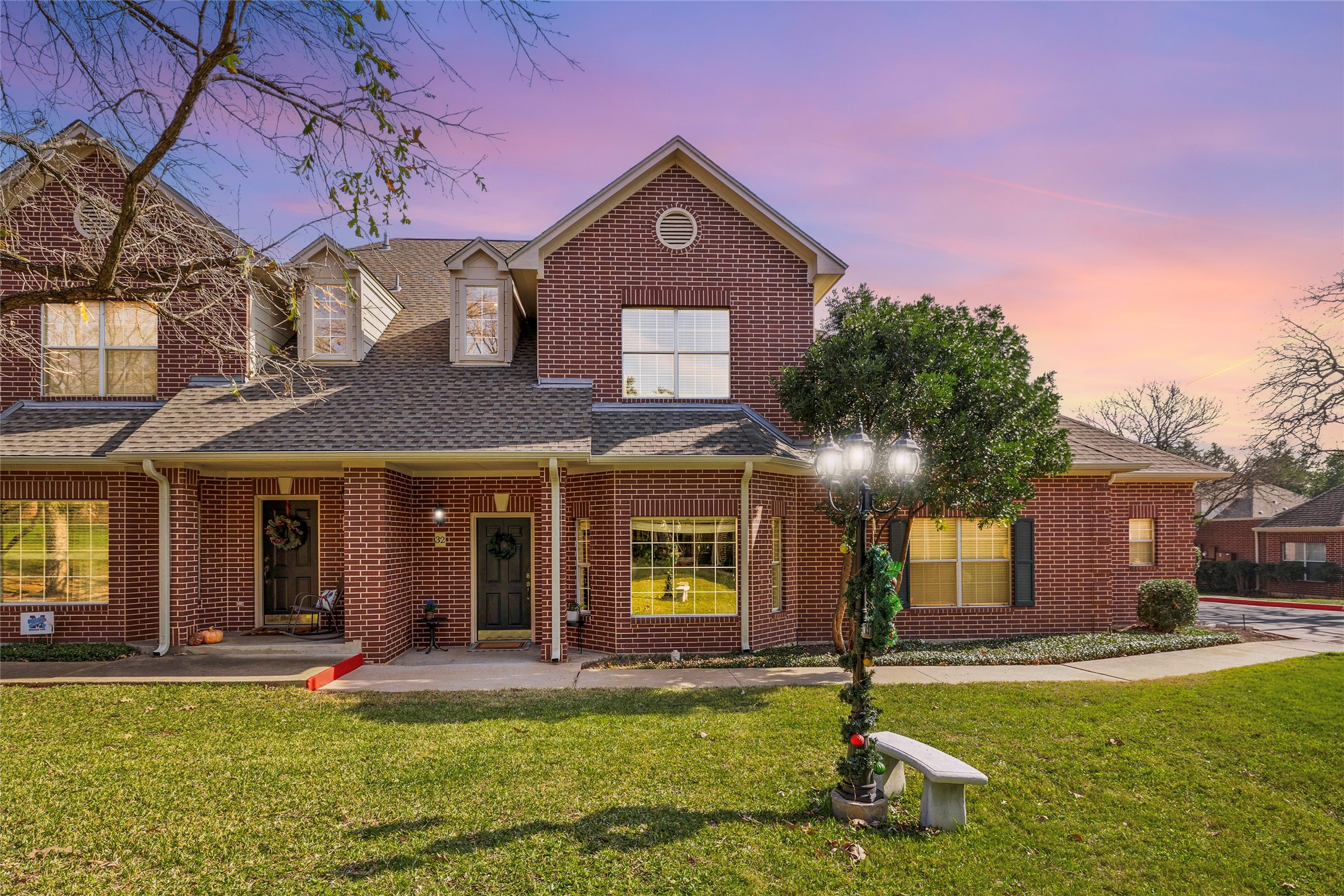 5515 Davis Lane, Unit 32 Austin, TX 78749 - Photo 1 of 40 a view of a brick house with a large windows and a yard in front of it