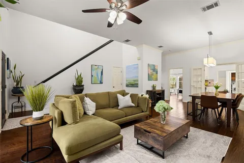 a living room with furniture potted plant and a chandelier