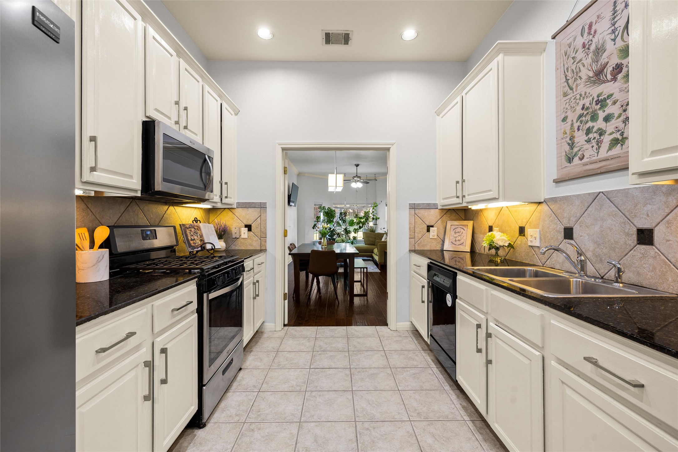5515 Davis Lane, Unit 32 Austin, TX 78749 - Photo 14 of 40 a kitchen with stainless steel appliances granite countertop a stove a sink and a refrigerator