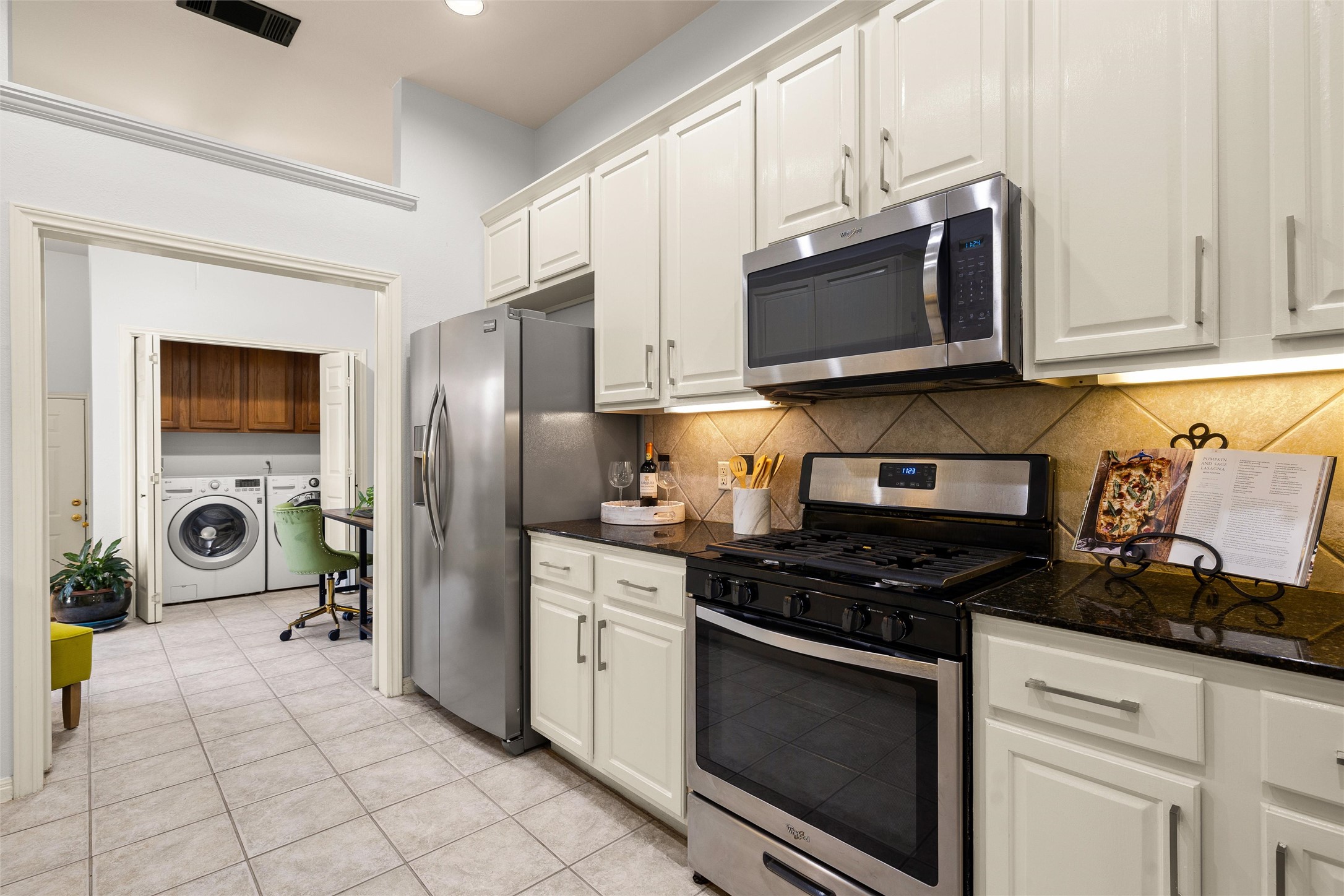 5515 Davis Lane, Unit 32 Austin, TX 78749 - Photo 16 of 40 a kitchen with stainless steel appliances a stove a microwave a sink a refrigerator and cabinets