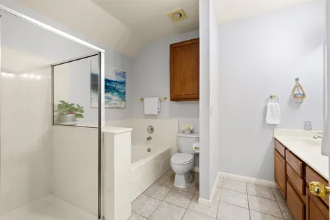a spacious bathroom with a sink toilet and shower