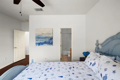 a bedroom with a bed and a painting on the wall