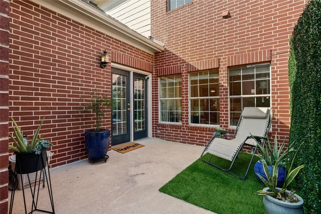 a view of a patio with table and chairs and potted plants