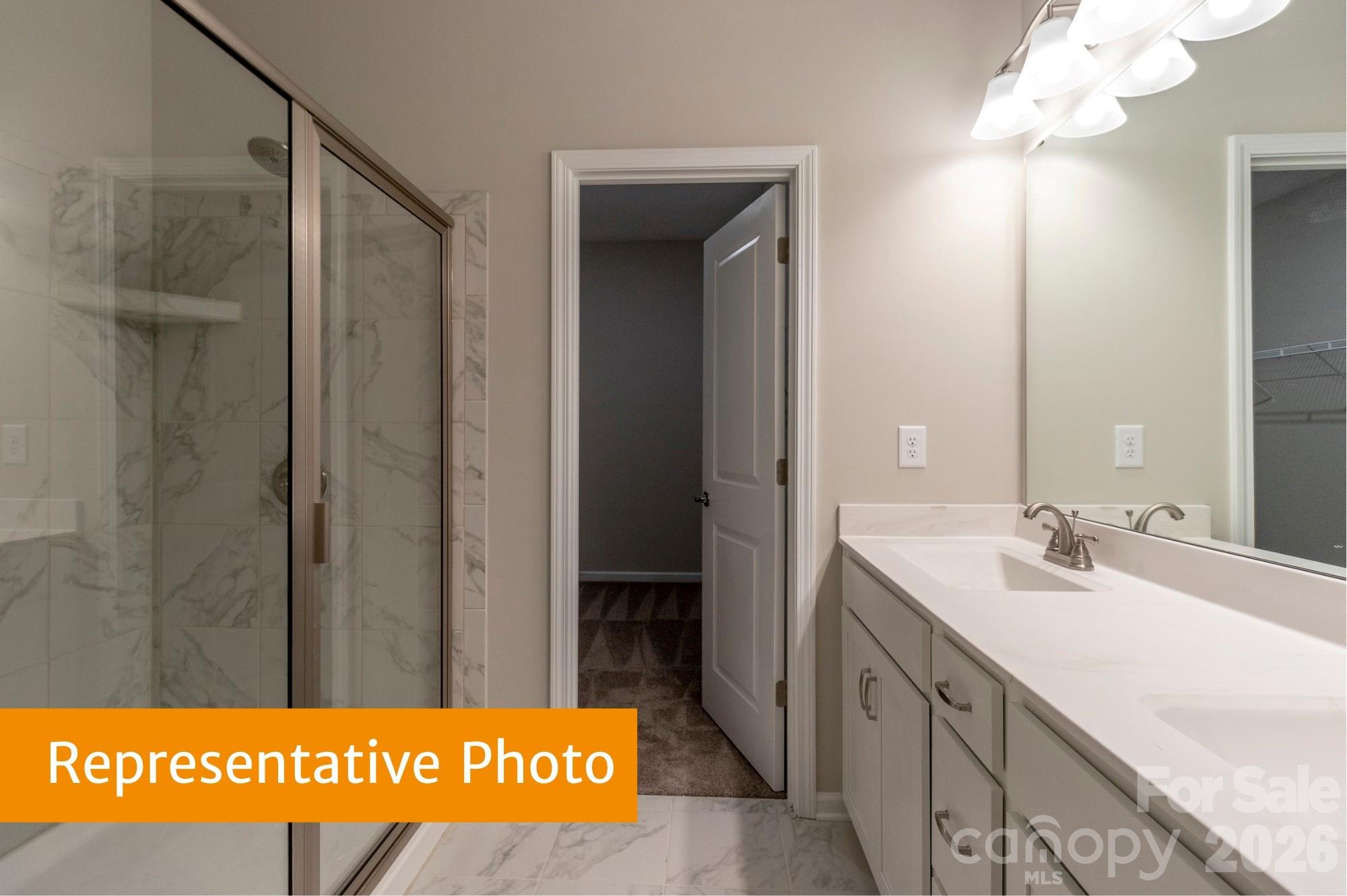 1918 Gibb Crossing Monroe, NC 28110 - Photo 13 of 19 a bathroom with a sink a mirror and a shower
