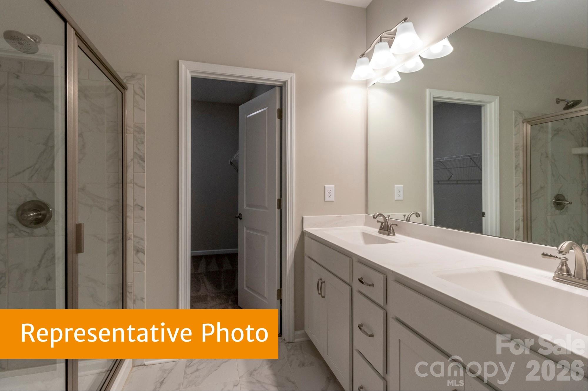 1918 Gibb Crossing Monroe, NC 28110 - Photo 3 of 19 a bathroom with a sink a mirror and a shower