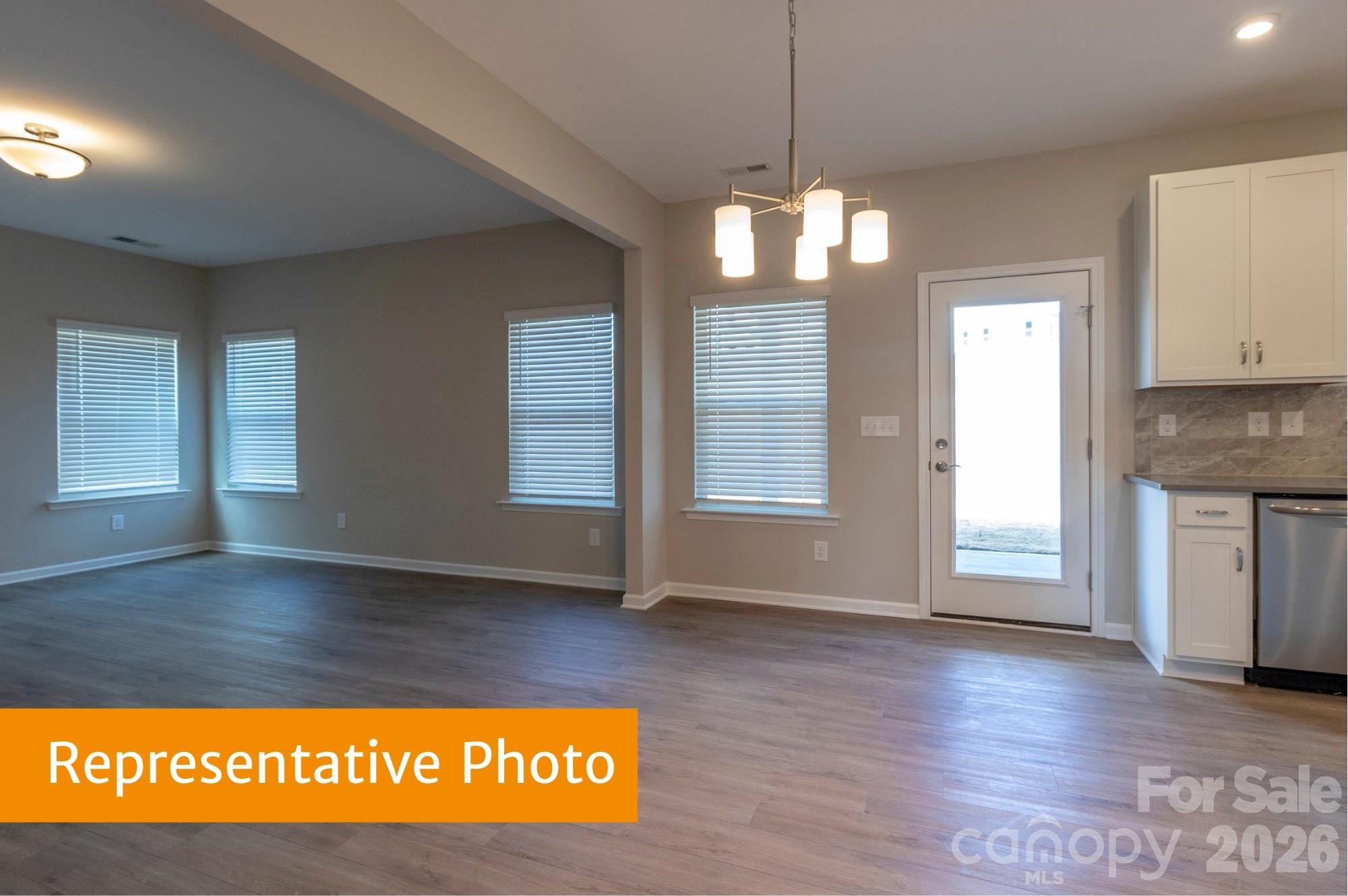 1918 Gibb Crossing Monroe, NC 28110 - Photo 6 of 19 a view of an empty room with window and wooden floor