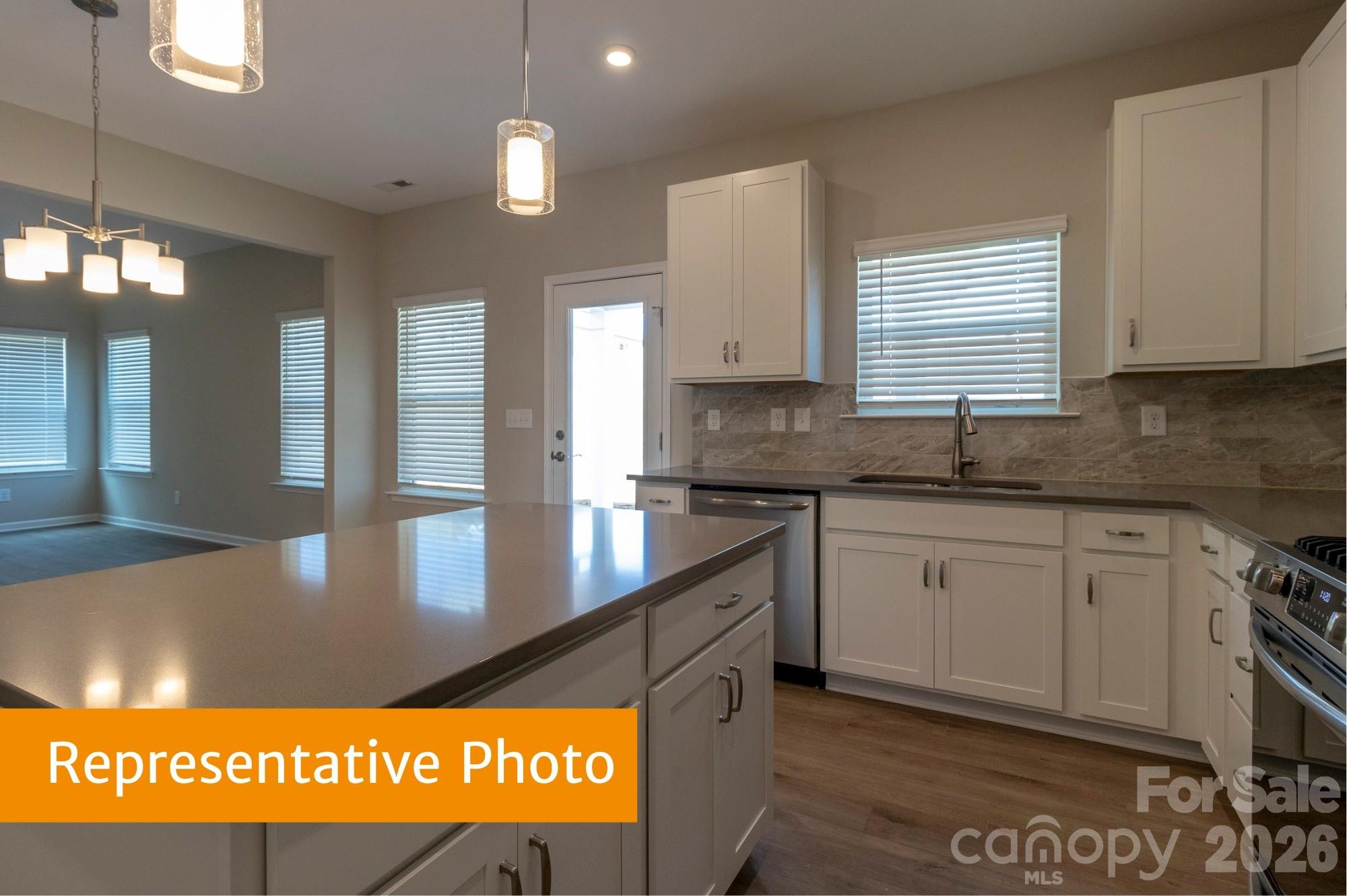 1918 Gibb Crossing Monroe, NC 28110 - Photo 8 of 19 a kitchen with stainless steel appliances granite countertop a sink window and cabinets
