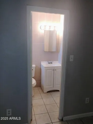 a bathroom with a sink a toilet and mirror