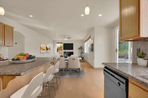 a living room with furniture and a kitchen